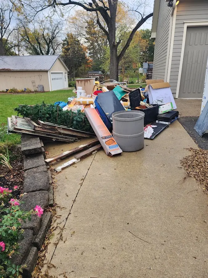 Dumpster being loaded with debris for 12 Yard Dumpster Rental in Mooresville
